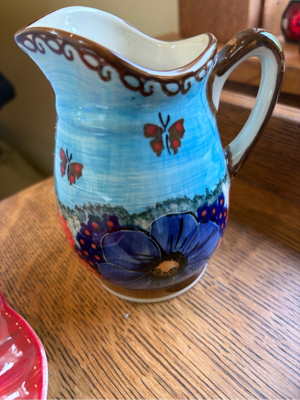 Blue Floral Ceramic Pitcher with Butterfly Accent